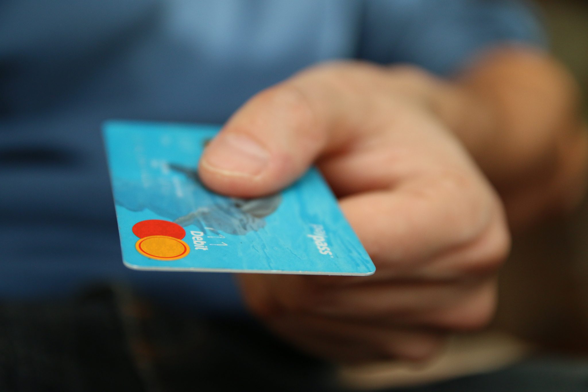 close-up of a hand holding a Mastercard, capture leads, get leads online